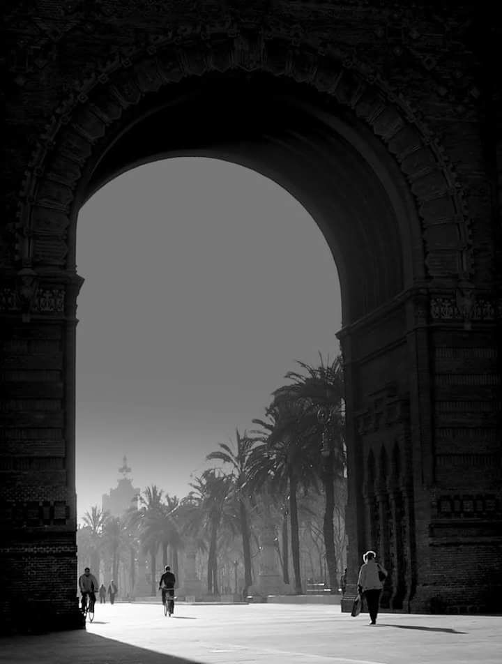 Arc de Triomf archway in Barcelona with palm-lined promenade beyond